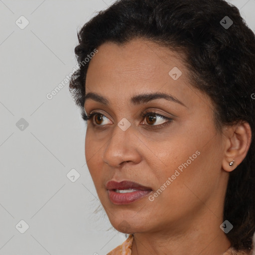 Joyful latino young-adult female with long  black hair and brown eyes