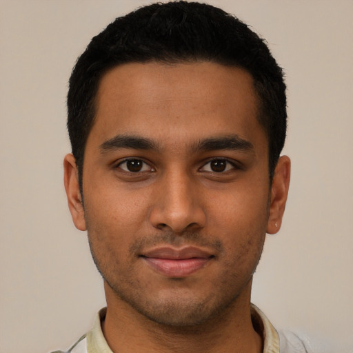 Joyful latino young-adult male with short  black hair and brown eyes
