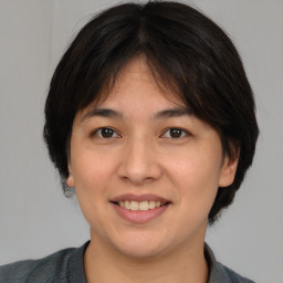 Joyful white young-adult female with medium  brown hair and brown eyes