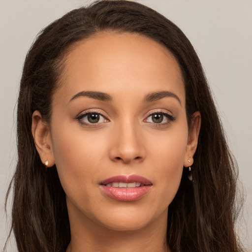 Joyful white young-adult female with long  brown hair and brown eyes