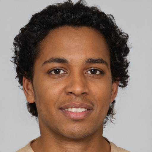 Joyful black young-adult male with short  brown hair and brown eyes