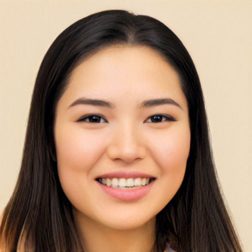 Joyful asian young-adult female with long  black hair and brown eyes