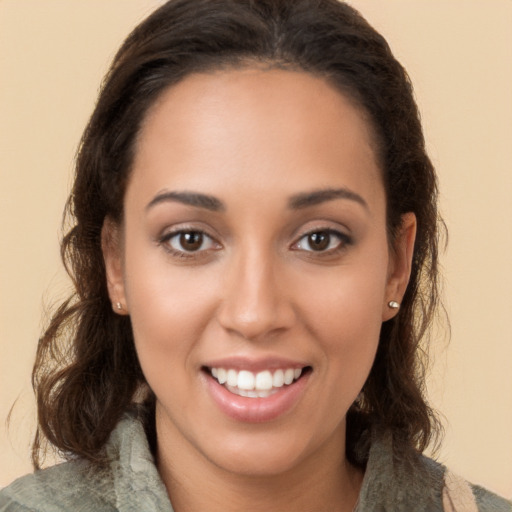 Joyful white young-adult female with long  brown hair and brown eyes