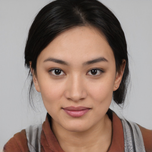 Joyful latino young-adult female with medium  black hair and brown eyes