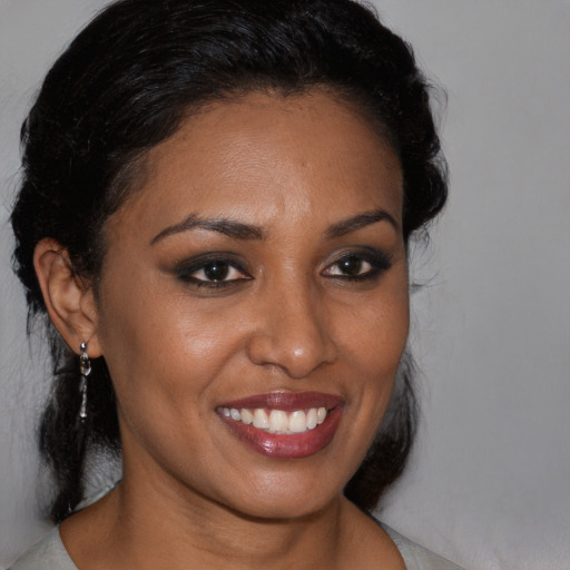 Joyful black young-adult female with medium  brown hair and brown eyes