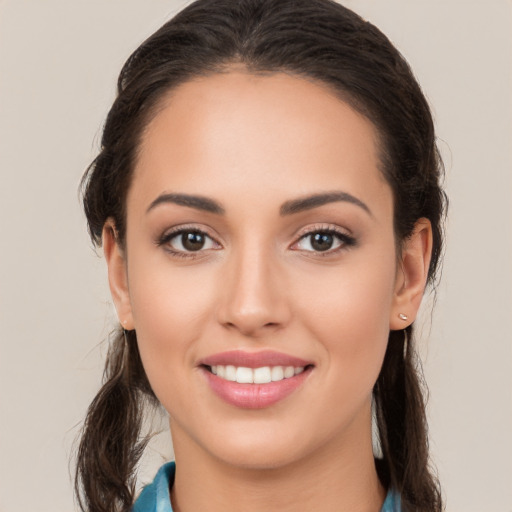 Joyful white young-adult female with long  brown hair and brown eyes