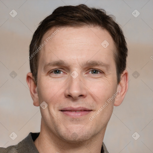 Joyful white adult male with short  brown hair and grey eyes