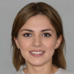 Joyful white young-adult female with medium  brown hair and brown eyes