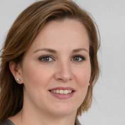 Joyful white young-adult female with medium  brown hair and blue eyes