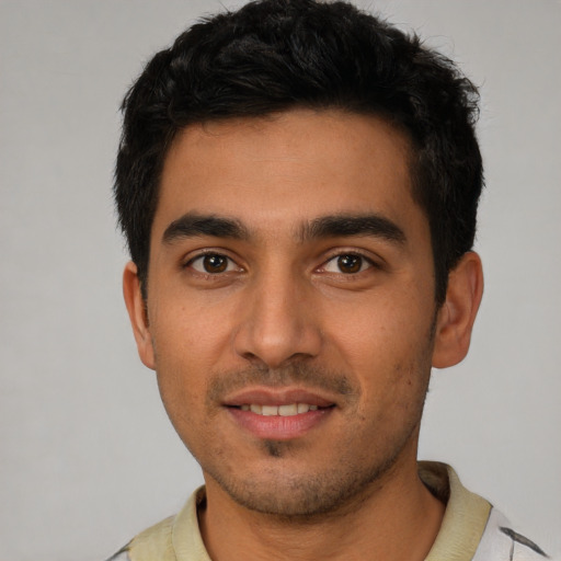 Joyful white young-adult male with short  black hair and brown eyes