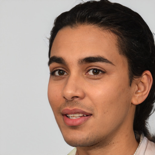 Joyful white young-adult male with short  black hair and brown eyes