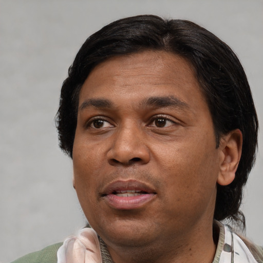 Joyful black adult male with short  black hair and brown eyes