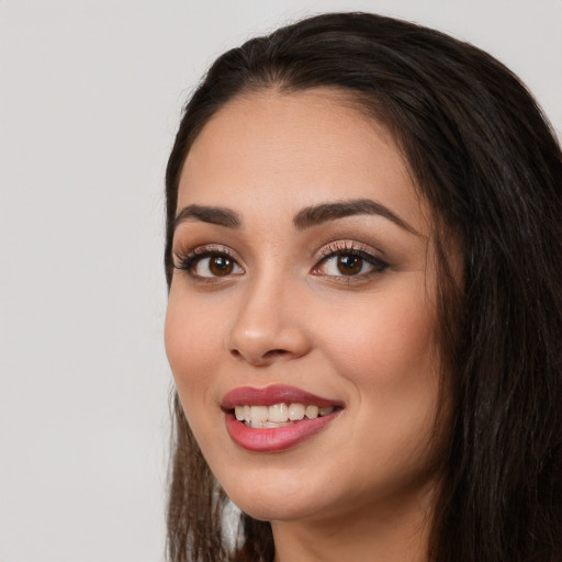 Joyful white young-adult female with long  black hair and brown eyes