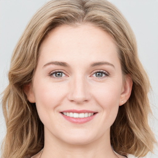 Joyful white young-adult female with long  brown hair and blue eyes