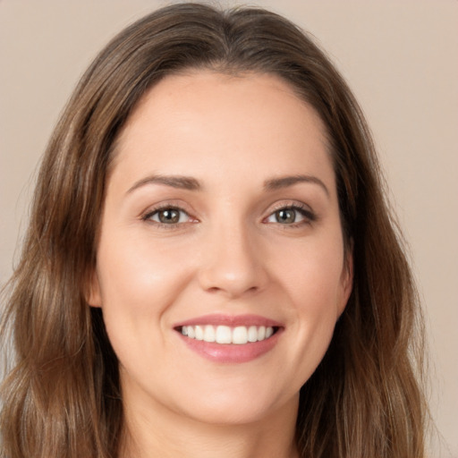 Joyful white young-adult female with long  brown hair and brown eyes