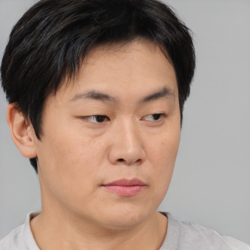 Neutral asian young-adult male with short  brown hair and brown eyes