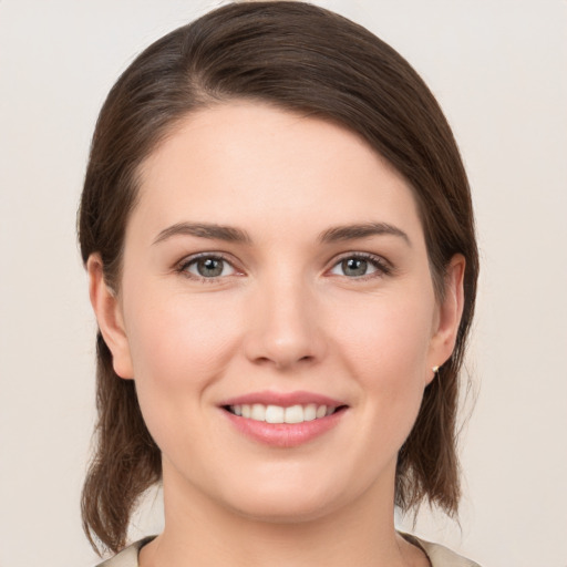 Joyful white young-adult female with medium  brown hair and brown eyes