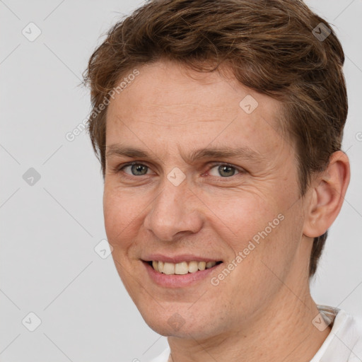 Joyful white adult male with short  brown hair and brown eyes