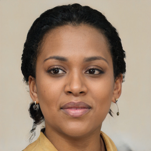 Joyful black young-adult female with short  brown hair and brown eyes