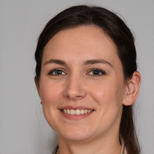 Joyful white young-adult female with medium  brown hair and brown eyes