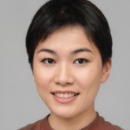 Joyful asian young-adult female with short  brown hair and brown eyes