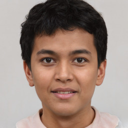 Joyful latino young-adult male with short  brown hair and brown eyes