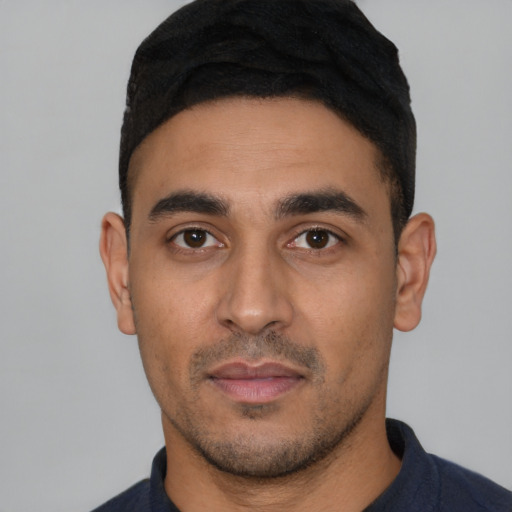 Neutral latino young-adult male with short  black hair and brown eyes