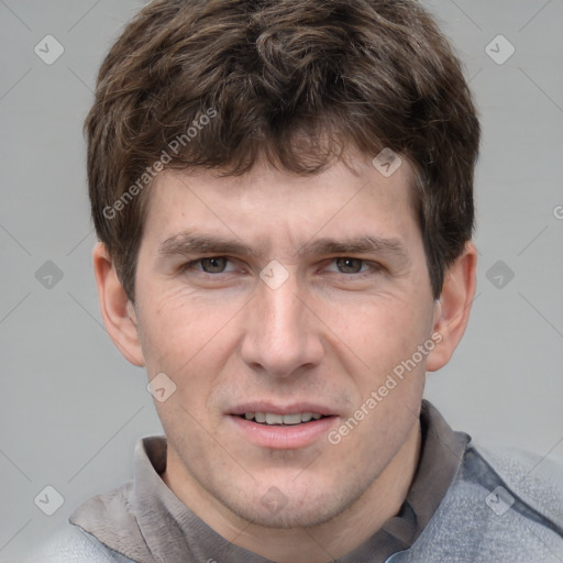 Joyful white adult male with short  brown hair and grey eyes