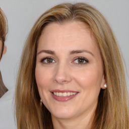 Joyful white adult female with long  brown hair and brown eyes