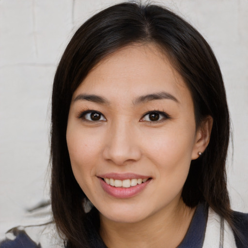 Joyful asian young-adult female with medium  brown hair and brown eyes