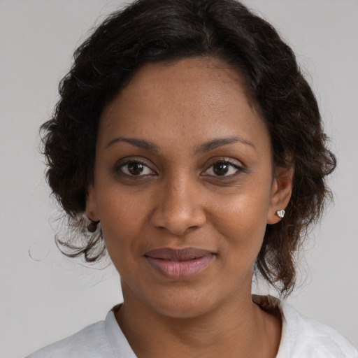 Joyful black young-adult female with medium  brown hair and brown eyes