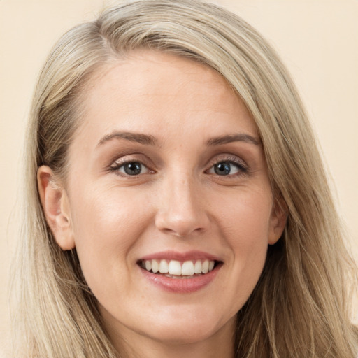 Joyful white young-adult female with long  brown hair and green eyes