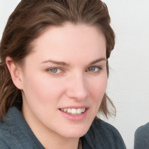 Joyful white young-adult female with medium  brown hair and blue eyes