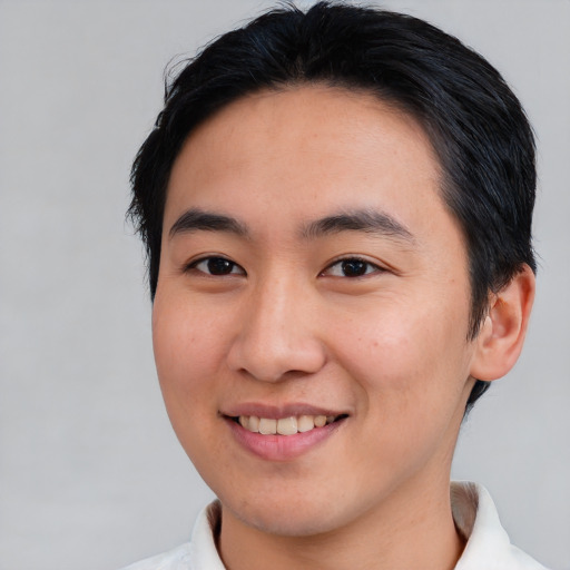 Joyful asian young-adult male with medium  brown hair and brown eyes