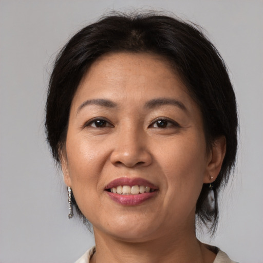 Joyful white adult female with medium  brown hair and brown eyes