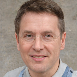 Joyful white adult male with short  brown hair and grey eyes