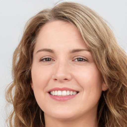 Joyful white young-adult female with long  brown hair and green eyes