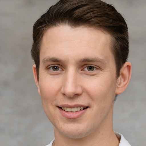 Joyful white adult male with short  brown hair and grey eyes