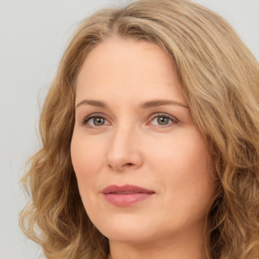 Joyful white adult female with long  brown hair and brown eyes