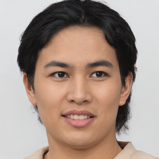 Joyful asian young-adult female with medium  brown hair and brown eyes