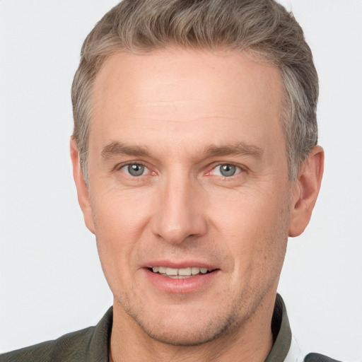 Joyful white adult male with short  brown hair and grey eyes