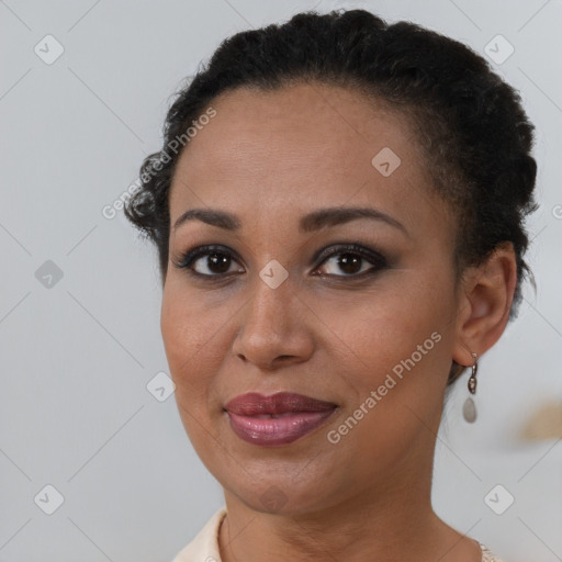 Joyful black young-adult female with short  brown hair and brown eyes