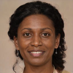 Joyful black adult female with medium  brown hair and brown eyes