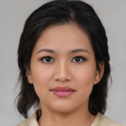 Joyful asian young-adult female with medium  brown hair and brown eyes