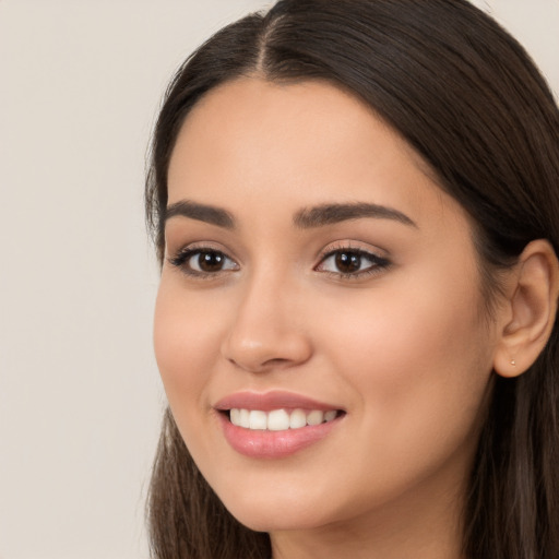 Joyful white young-adult female with long  brown hair and brown eyes