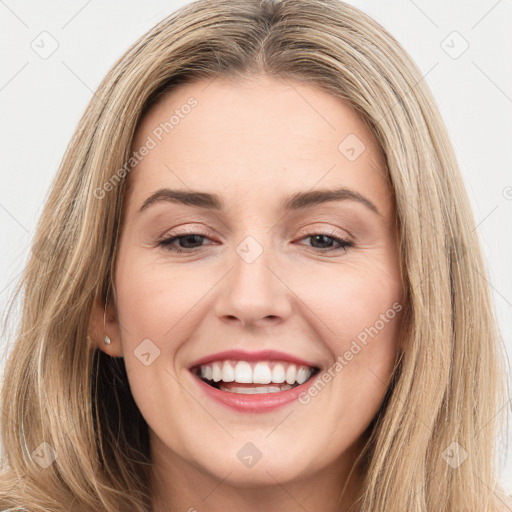 Joyful white young-adult female with long  brown hair and brown eyes