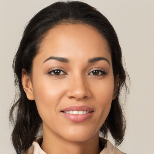 Joyful latino young-adult female with medium  brown hair and brown eyes