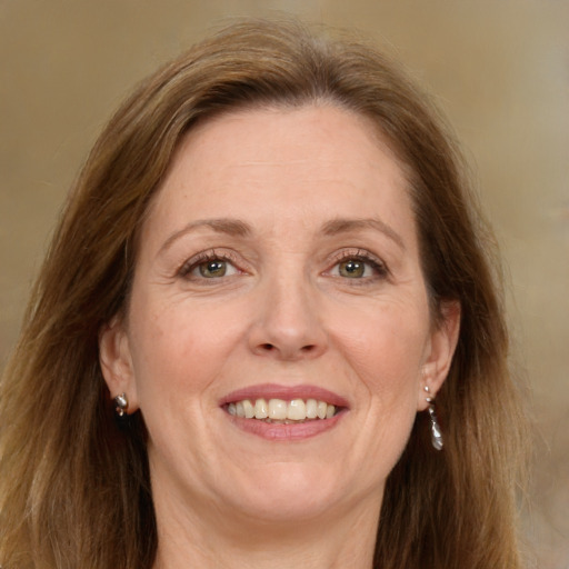 Joyful white adult female with medium  brown hair and green eyes