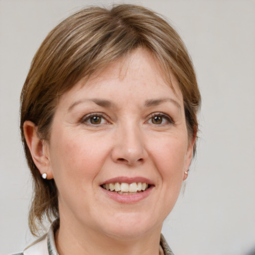 Joyful white adult female with medium  brown hair and grey eyes