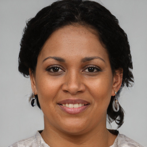 Joyful black adult female with short  brown hair and brown eyes